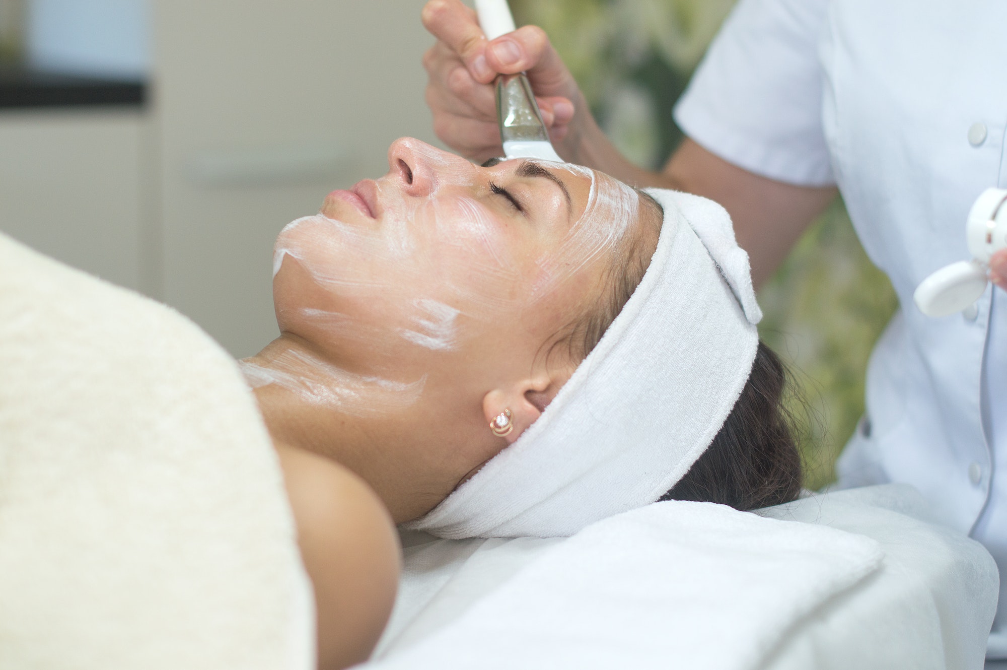 Woman having facial cleansing at beauty spa